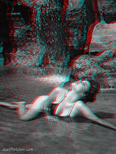  Georgeous girl swims in waterfall pool. 