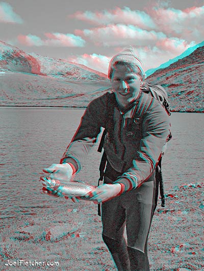 Fisherman displays trout.