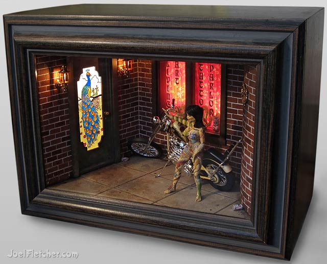 A miniature tattoo parlor with tattooed girl and chopped motorcycle