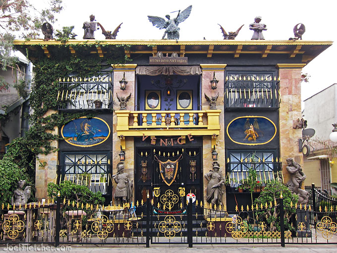 A wildly decorated building, populated with numerous metal statues and gargoyles.